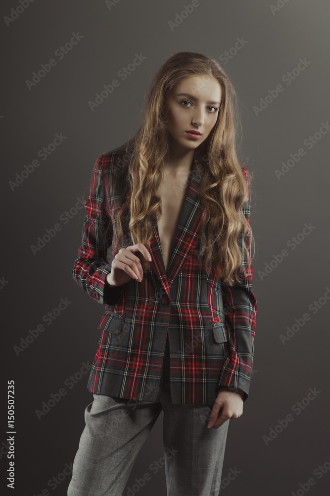 Pretty blonde woman posing for model tests in checkered jacket Pretty blonde woman posing for model tests in checkered jacket