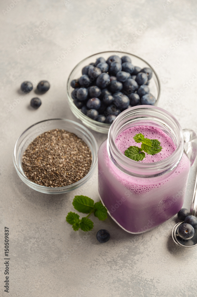 Blueberry smoothie with chia seeds in glass jar on grey concrete background, selective focus Blueberry smoothie with chia seeds in glass jar on grey concrete background, selective focus