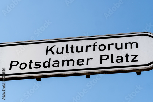 Kulturforum and Potsdamer Platz signpost against blue sky