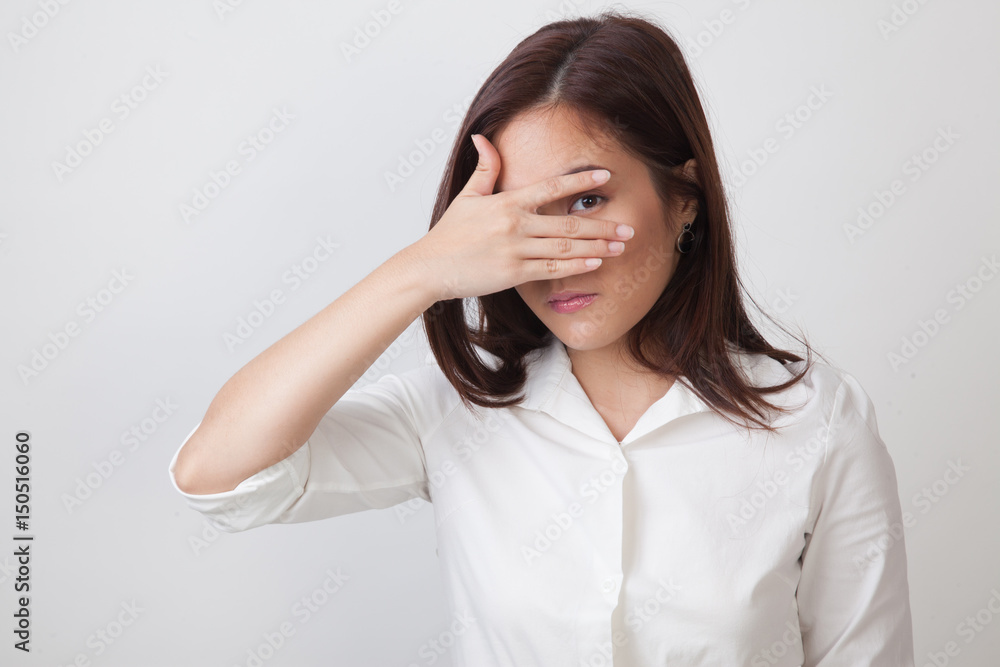 Beautiful young Asian woman peeking through fingers. Beautiful young Asian woman peeking through fingers.