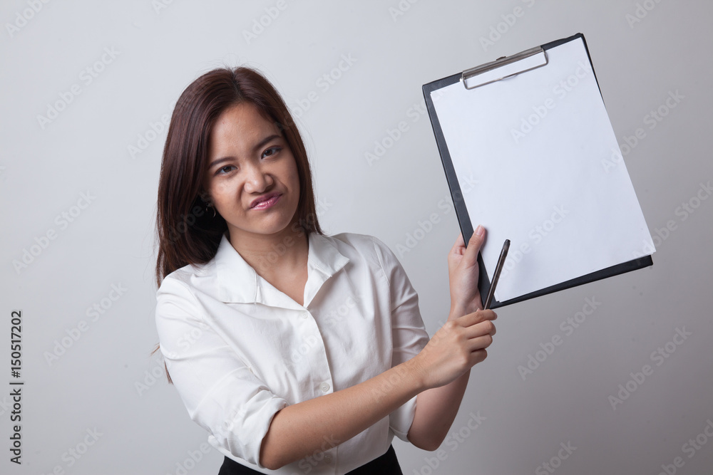 Unhappy Asian business woman point to clipboard with pen. Unhappy Asian business woman point to clipboard with pen.