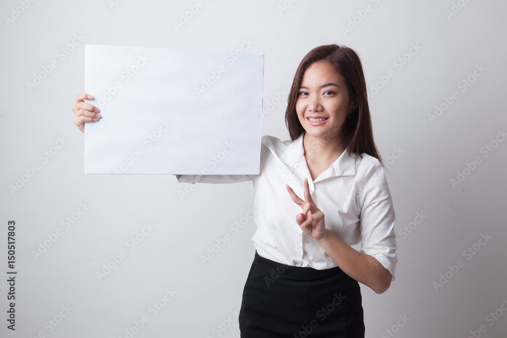Young Asian business woman show victory sign with blank sign. Young Asian business woman show victory sign with blank sign.