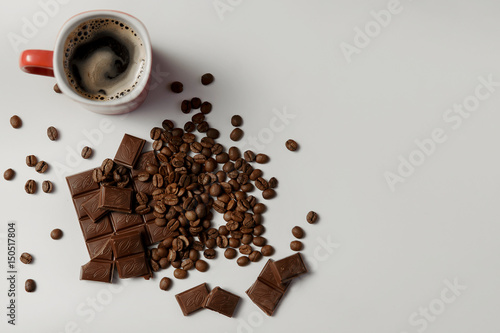 cup of fragrant coffee, beans coffee and chocolate on white background.