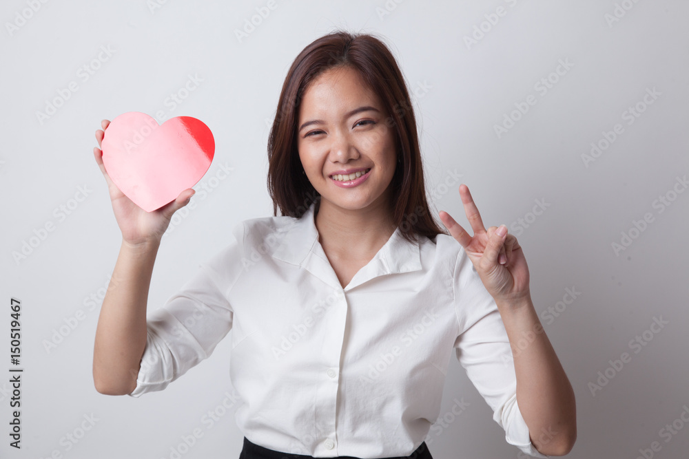 Asian business woman show victory sign with red heart. Asian business woman show victory sign with red heart.