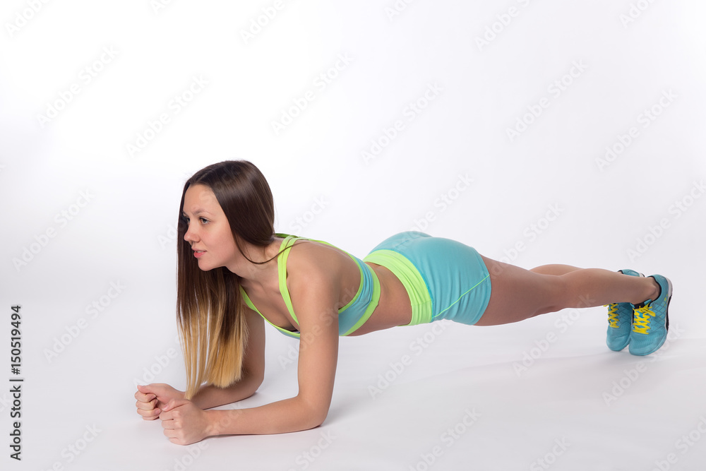 Woman in sportswear doing plank exercises Woman in sportswear doing plank exercises