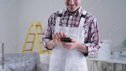 Professional painter using a smartphone