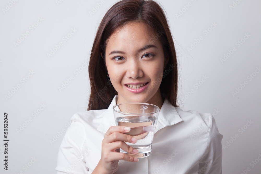 Young Asian woman with a glass of drinking water. Young Asian woman with a glass of drinking water.
