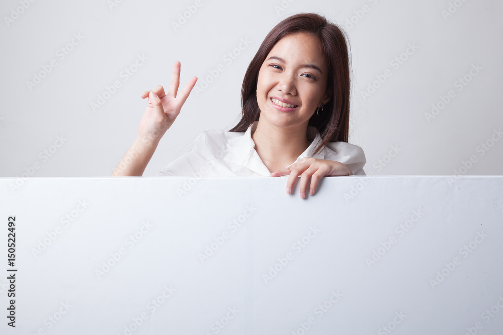 Young Asian woman show victory sign with blank sign.