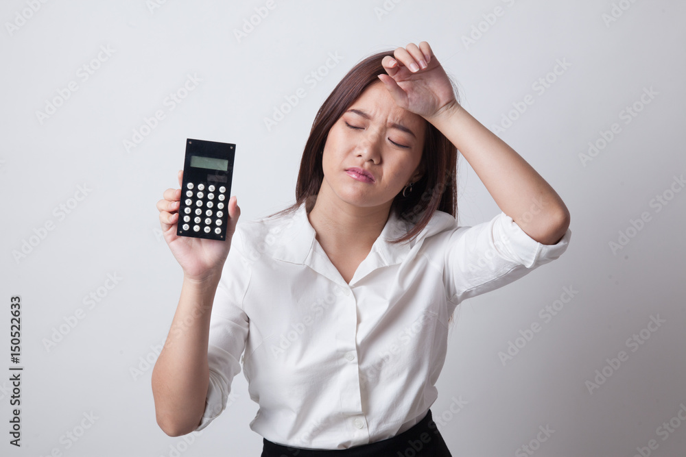 Asian woman got headache with calculator. Asian woman got headache with calculator.