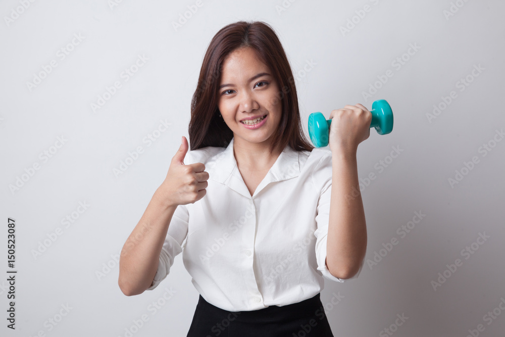 Healthy Asian woman thumbs up with dumbbells. Healthy Asian woman thumbs up with dumbbells.