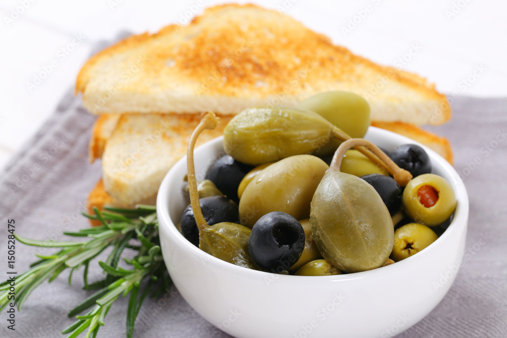 pickled olives, capers and caper berries with toast pickled olives, capers and caper berries with toast