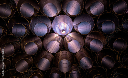 Aluminum HVAC Ducting piled up ready to use at a construction site creating an abstract pattern