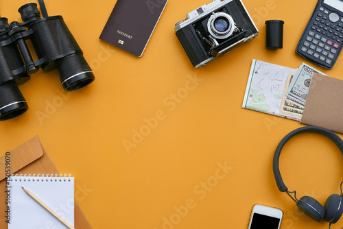 Accessories on orange desk background of photographer