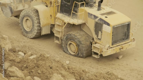 Excavator with a flat tire going backwards