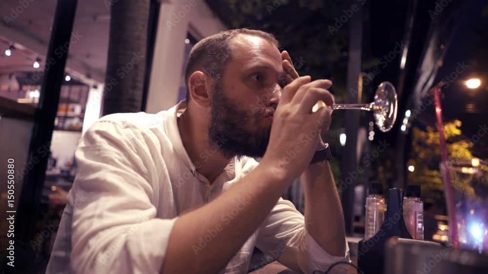 Sad, unhappy man drinking wine sitting in cafe during evening, 4K
Sad, unhappy man drinking wine sitting in cafe during evening, 4K