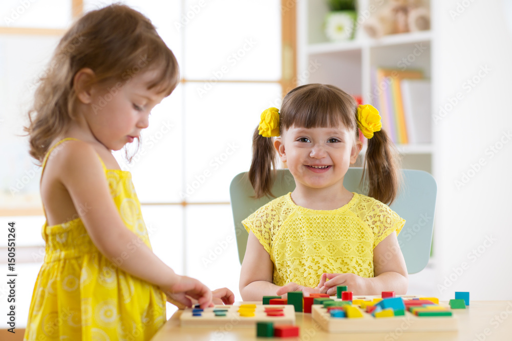 Fototapeta premium Caucasian child sisters playing together