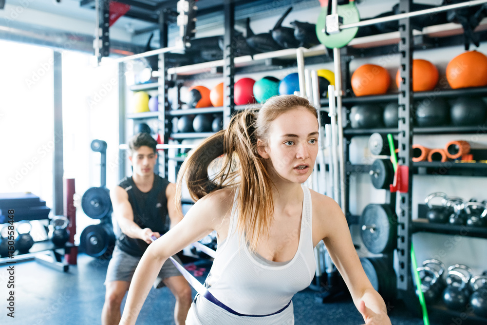 Fototapeta premium Strong woman using a resistance band in her exercise routine.