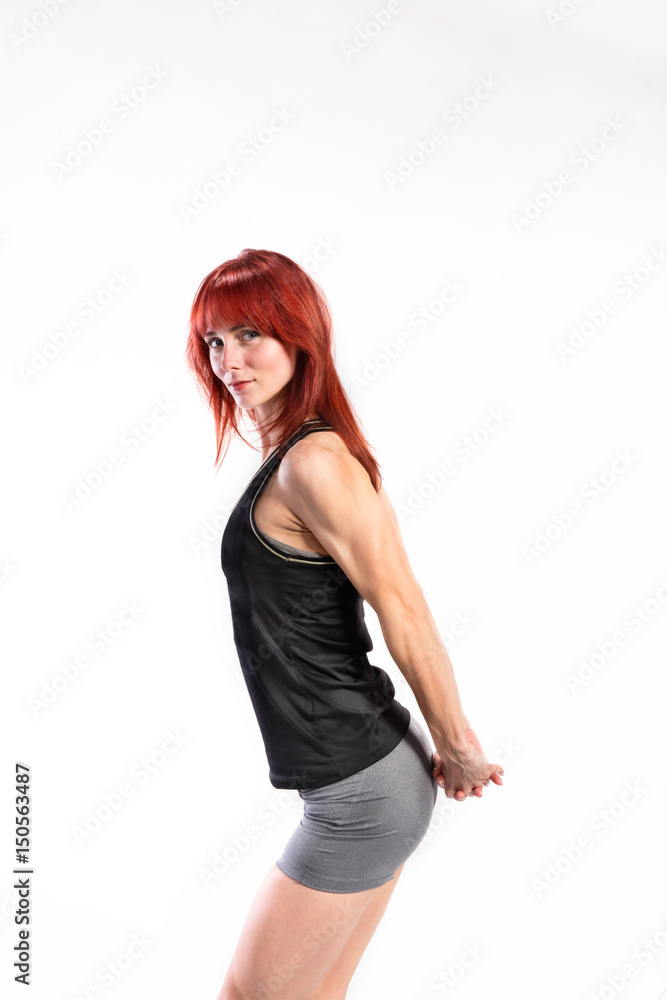 Attractive young fitness woman in black tank top. Studio shot. Attractive young fitness woman in black tank top. Studio shot.
