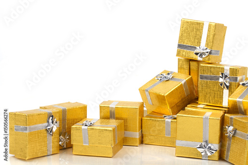 A pile of gold gifts on white