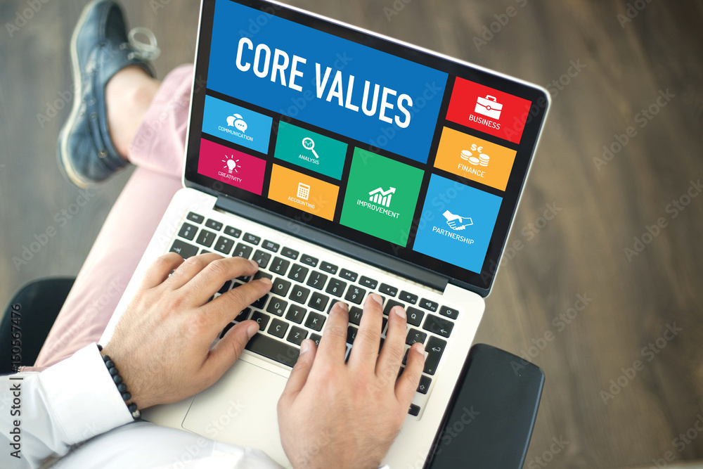 People using laptop in an office and CORE VALUES concept on screen People using laptop in an office and CORE VALUES concept on screen