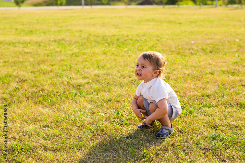 Summer, childhood and baby concept - little boy having fun in summer nature. Summer, childhood and baby concept - little boy having fun in summer nature.