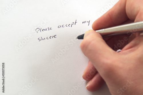 Please accept my sincere ... (apologies) in handwriting by hand with pen on white paper