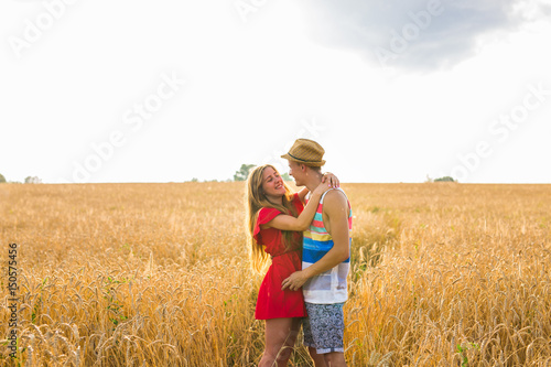 Young love couple standing on field