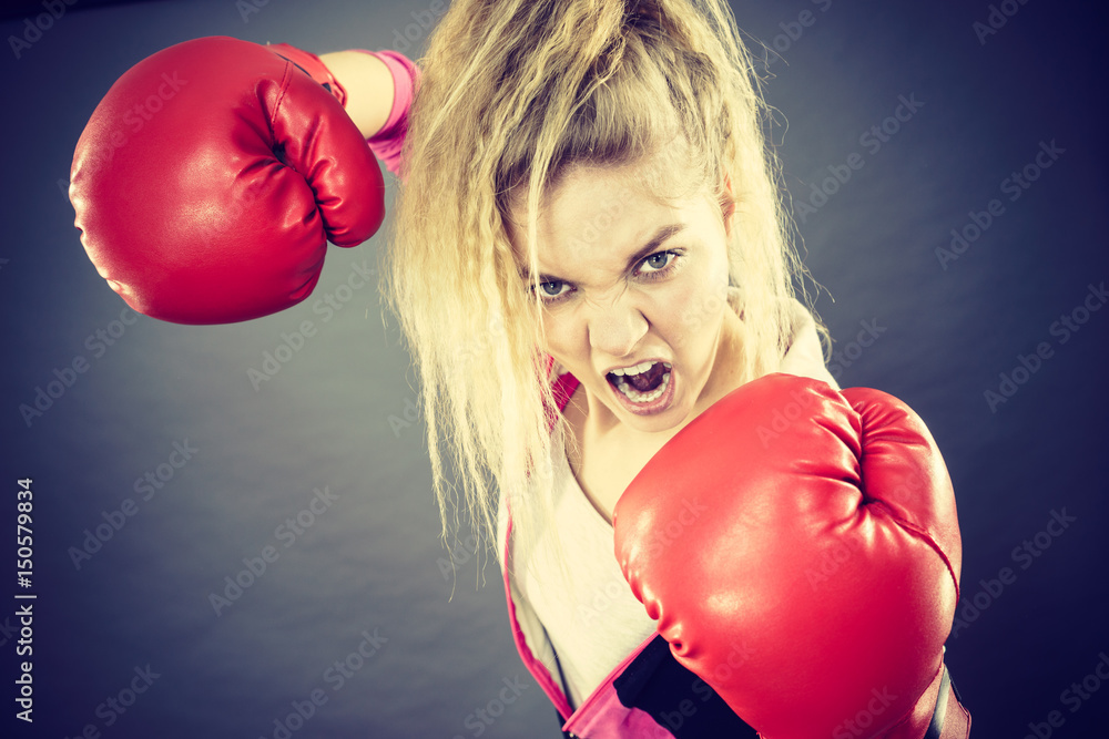 Angry woman wearing boxing gloves Angry woman wearing boxing gloves