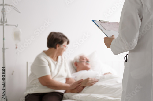 Supporting wife listening doctor's diagnosis