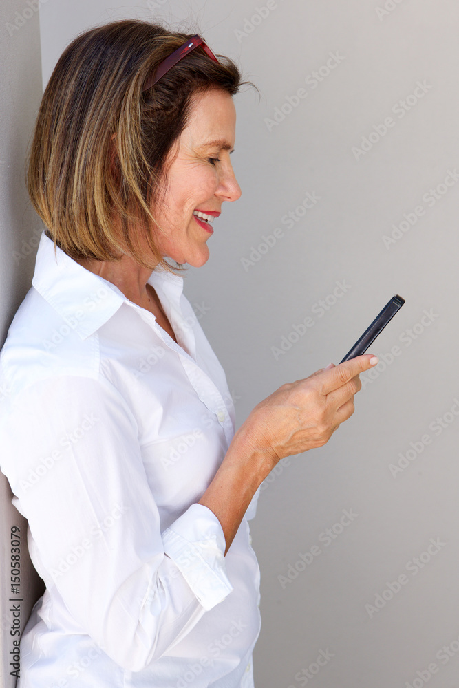 businesswoman looking at mobile phone businesswoman looking at mobile phone