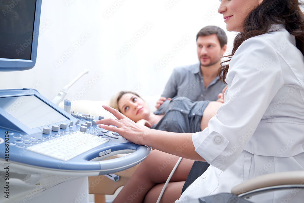 Fototapeta premium Cropped shot of a female doctor performing ultrasound scanning for her pregnant patient copyspace couple on the background examination diagnosis medical procedure technology health pregnancy.