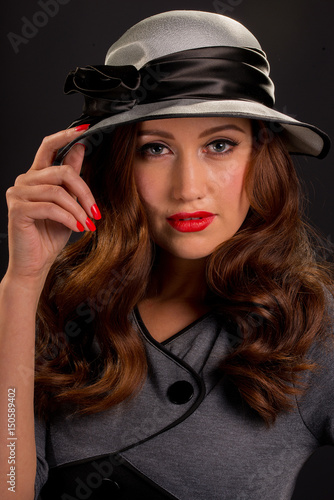 Vintage Style Portrait Of Beautiful Young Woman Wearing Hat.