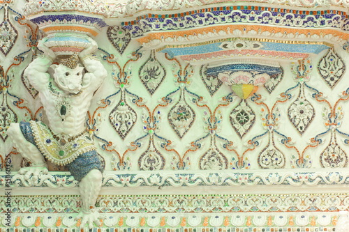 Sculpture of half human and wild boar monsters, demons, decorated with mosaic or stucco on the church wall at Wat Pariwat Temple, Bangkok, Thailand