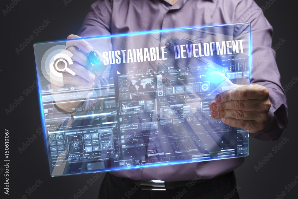 Business, Technology, Internet and network concept. Young businessman working on a virtual screen of the future and sees the inscription: Sustainable development Business, Technology, Internet and network concept. Young businessman working on a virtual screen of the future and sees the inscription: Sustainable development