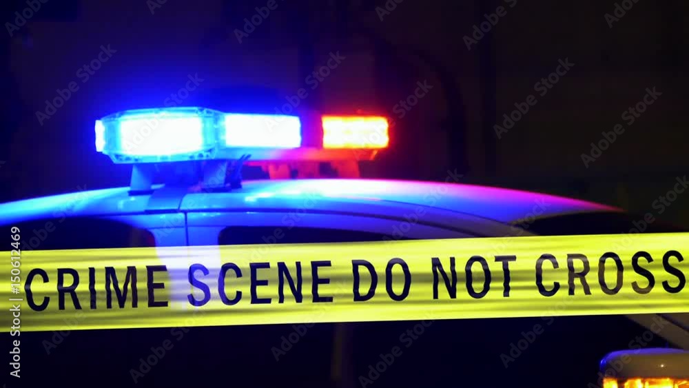 Crime scene tape with police car siren in background Crime scene tape with police car siren in background