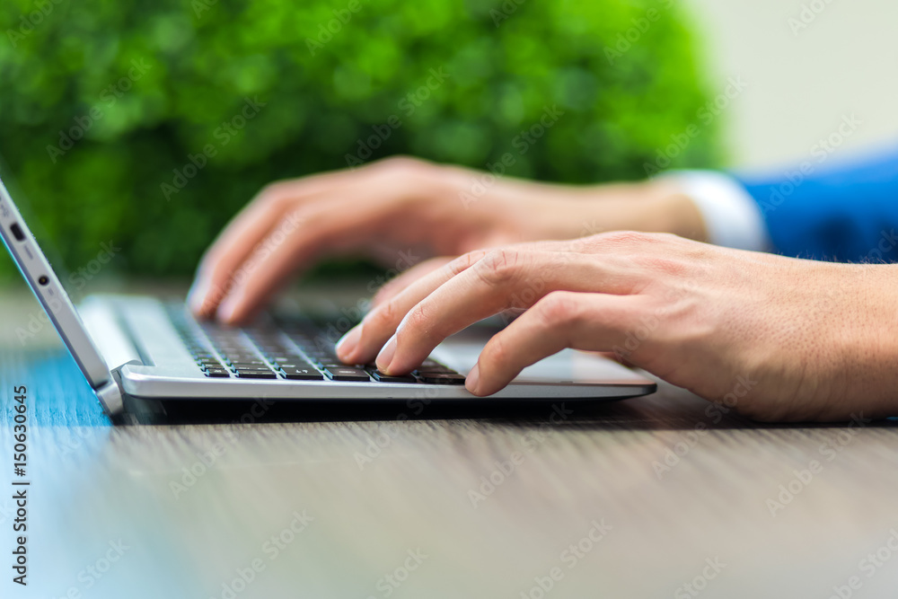 Male hands typing on a keyboard Male hands typing on a keyboard