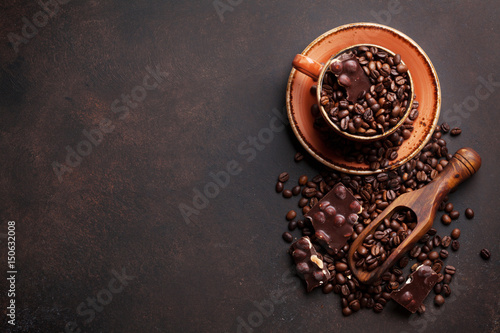 Coffee cup with roasted beans and chocolate