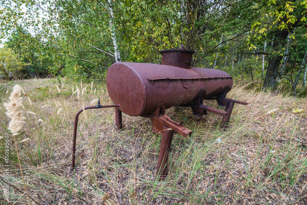 Old tank in collective farm near Zymovyshche ghost village in Chernobyl Exclusion Zone, Ukraine Old tank in collective farm near Zymovyshche ghost village in Chernobyl Exclusion Zone, Ukraine