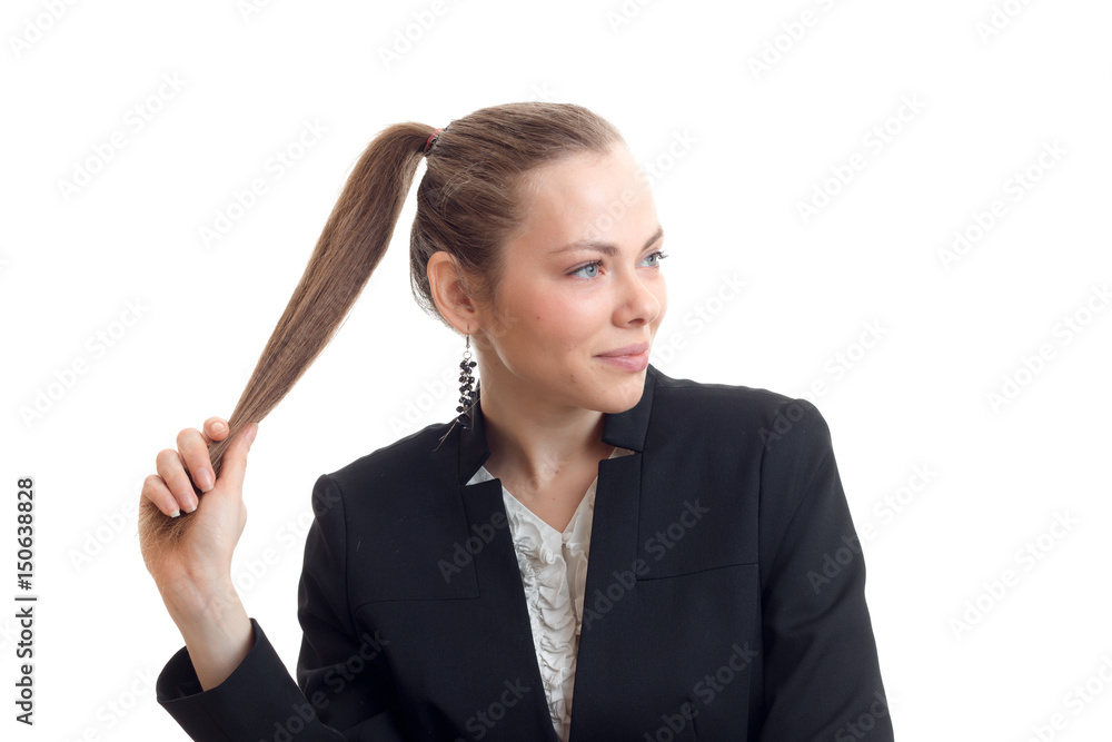 Portrait of a charming girl who looks away and keeps the tail hand Portrait of a charming girl who looks away and keeps the tail hand