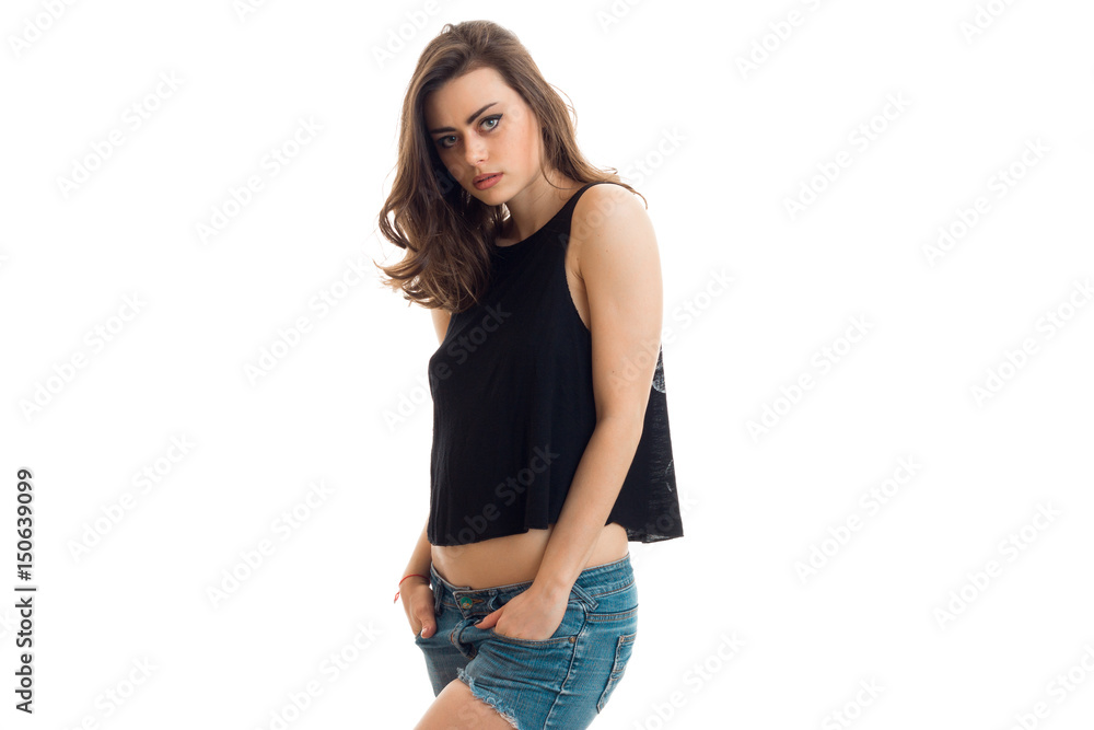 beautiful young brunette in black t-shirt stands sideways and posing for the camera beautiful young brunette in black t-shirt stands sideways and posing for the camera
