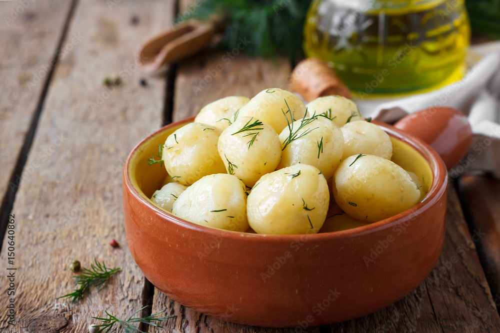 Boiled potatoes with dill on a wooden background Boiled potatoes with dill on a wooden background