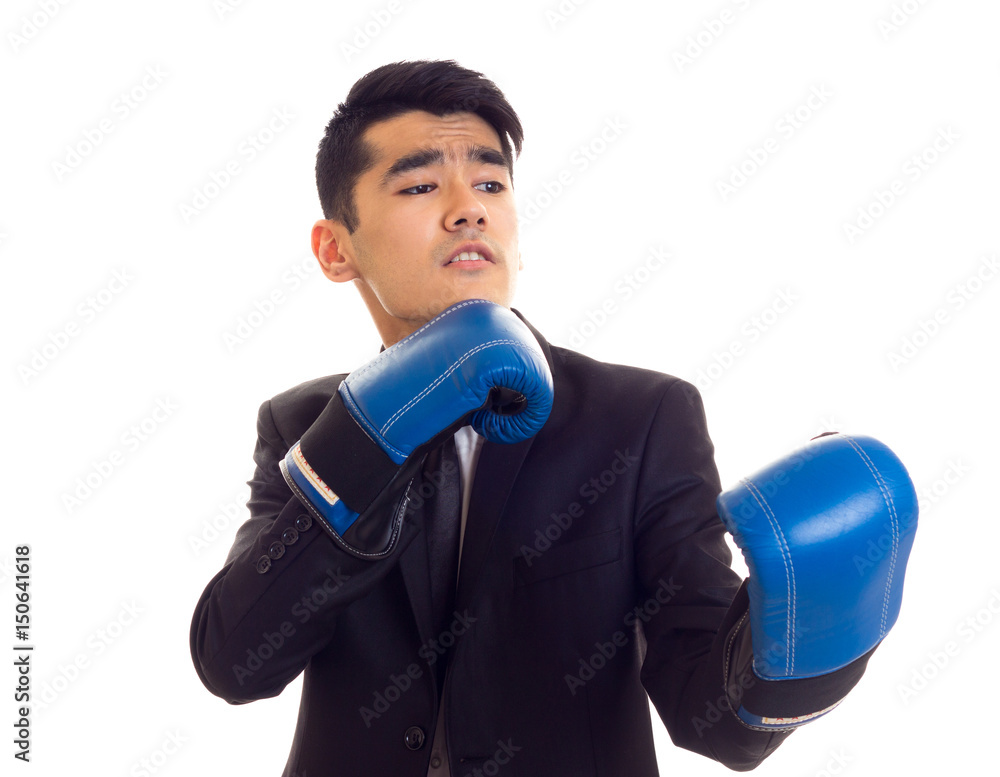 Young man in suit with boxing gloves Young man in suit with boxing gloves