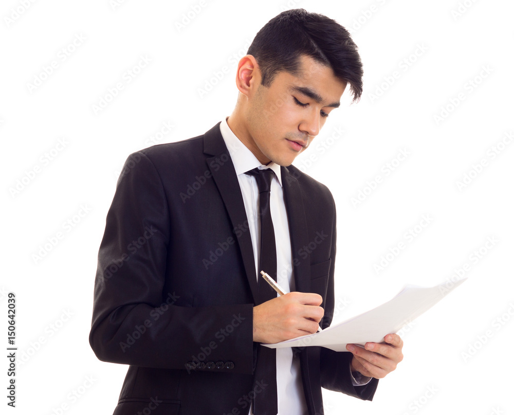 Young man in suit holding papers Young man in suit holding papers