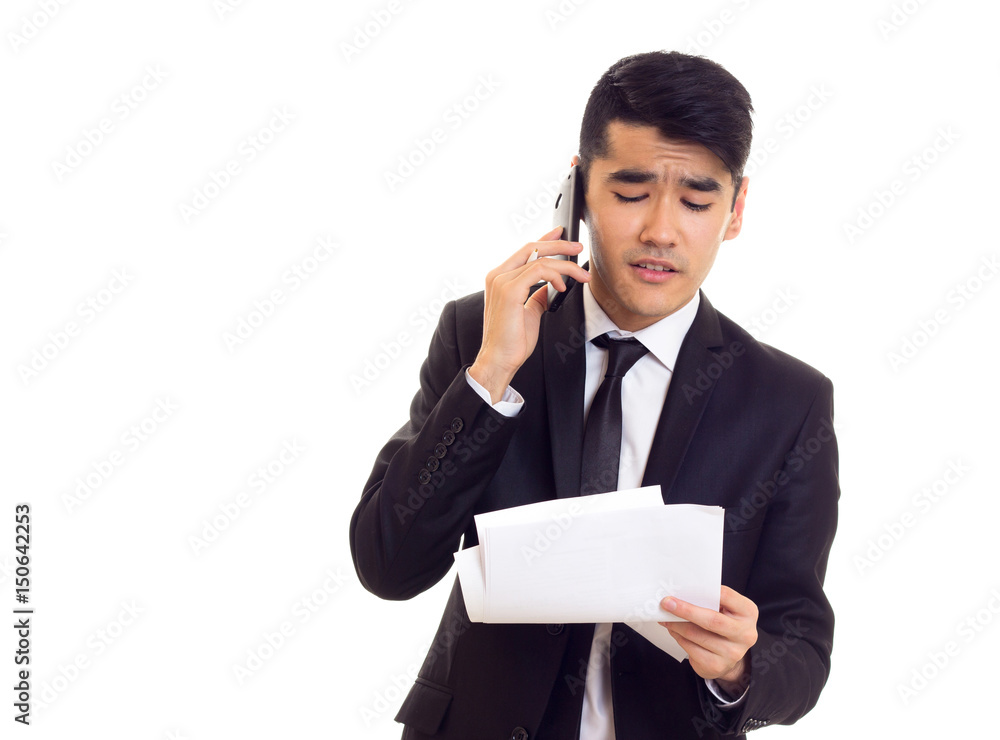 Young man in suit holding papers Young man in suit holding papers