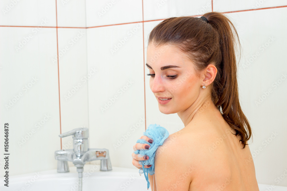 cute young girl to clean in the shower with a washcloth and a smiling Stock  Photo | Adobe Stock