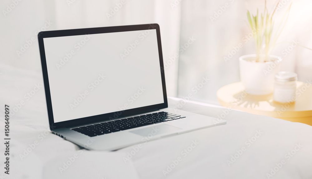 Mock-up of laptop with blank white screen on bed, Workplace fashion blogger early in the morning, Sunrise, Shallow DOF. Mock-up of laptop with blank white screen on bed, Workplace fashion blogger early in the morning, Sunrise, Shallow DOF.