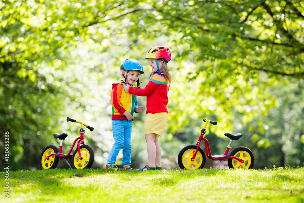 Kids ride balance bike in park Kids ride balance bike in park