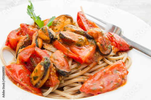 white dish with Pasta spaghetti   mussel and tomatoes