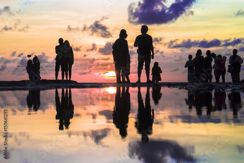beautiful silhouette of Photographers and Tourist photographing the sunset at Kuta beach, Bali, Indonesia