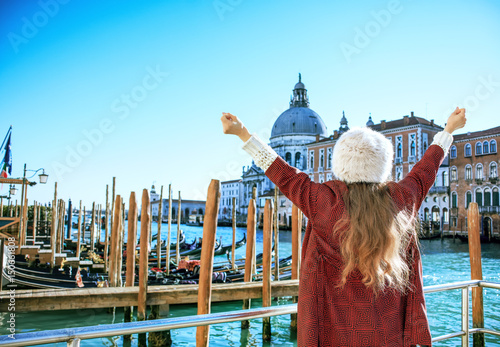 trendy tourist woman in Venice, Italy in winter rejoicing